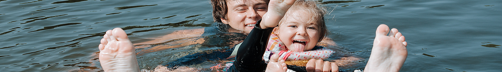 Man teaching small girl to waterboard