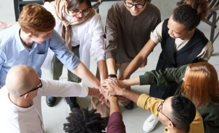 Supportive hands all united in the middle of a circle