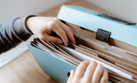 Hands reaching into a multi-file folder