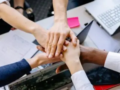 A group of hands gathered in support of each of other